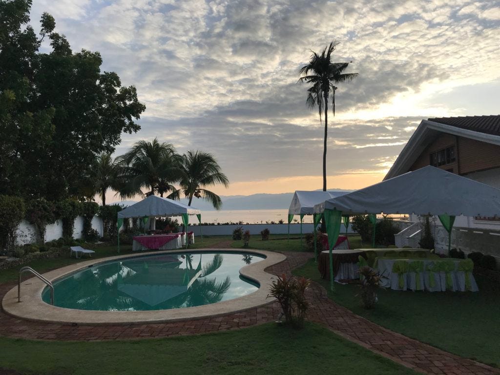 The pool. the palm trees, the white tablecloths