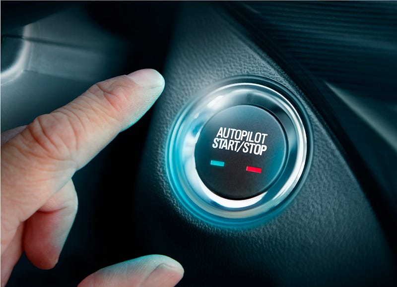 A finger hovers above a button in a car labeled “Autopilot Start/Stop.”