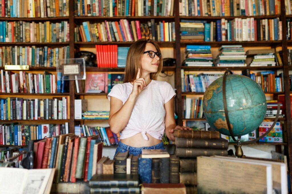 Young woman or girl in bookstore or library