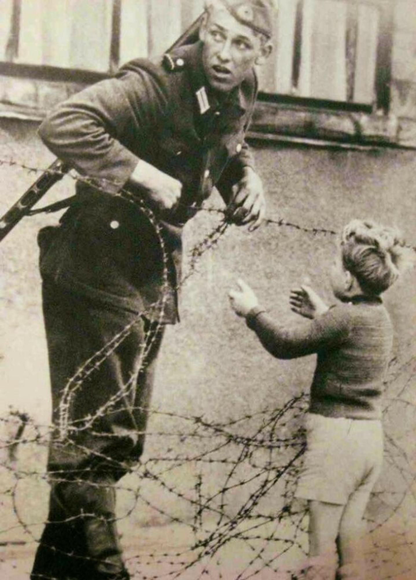 Incredible Photograph Of A German Soldier Going Against Direct Orders To  Help A Young Boy Cross The Newly Formed Berlin Wall After Being Separated  From His Family, 1961. : r/BeAmazed