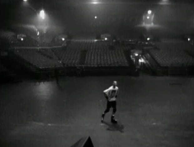 Thom Yorke rollerskating around an empty concert venue.