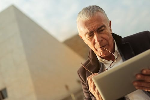 Free A Sad Man Using Silver Tablet Stock Photo