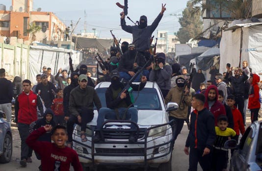 Palestinians and Hamas terrorists celebrate in Khan Younis