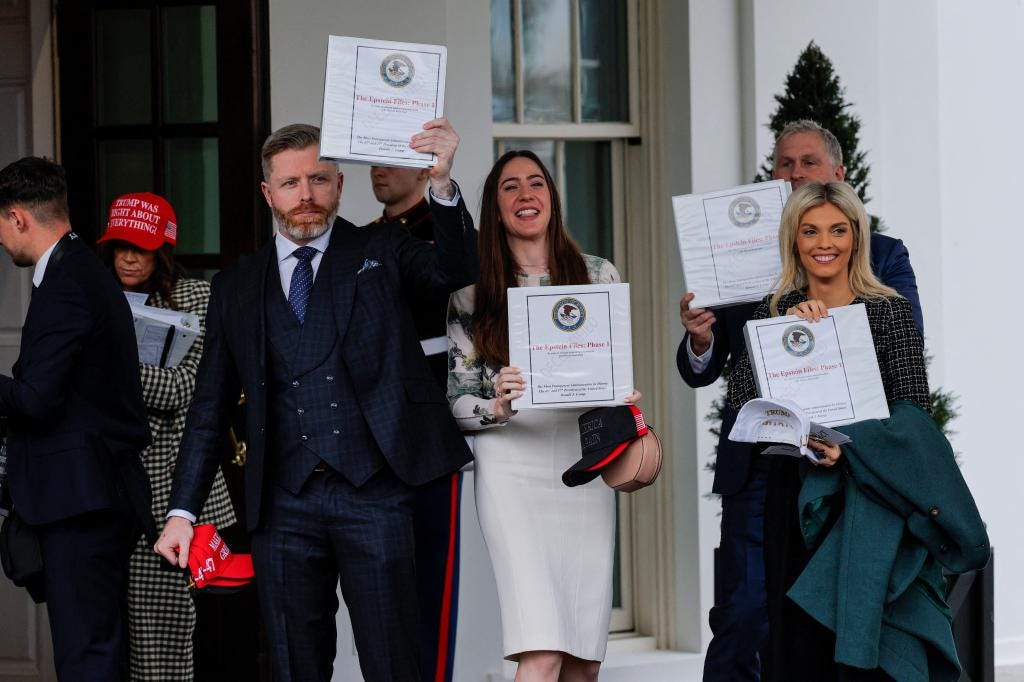 People exiting the West Wing of the White House displaying 'The Epstein Files: Phase 1' binders, Washington, D.C., February 27, 2025.