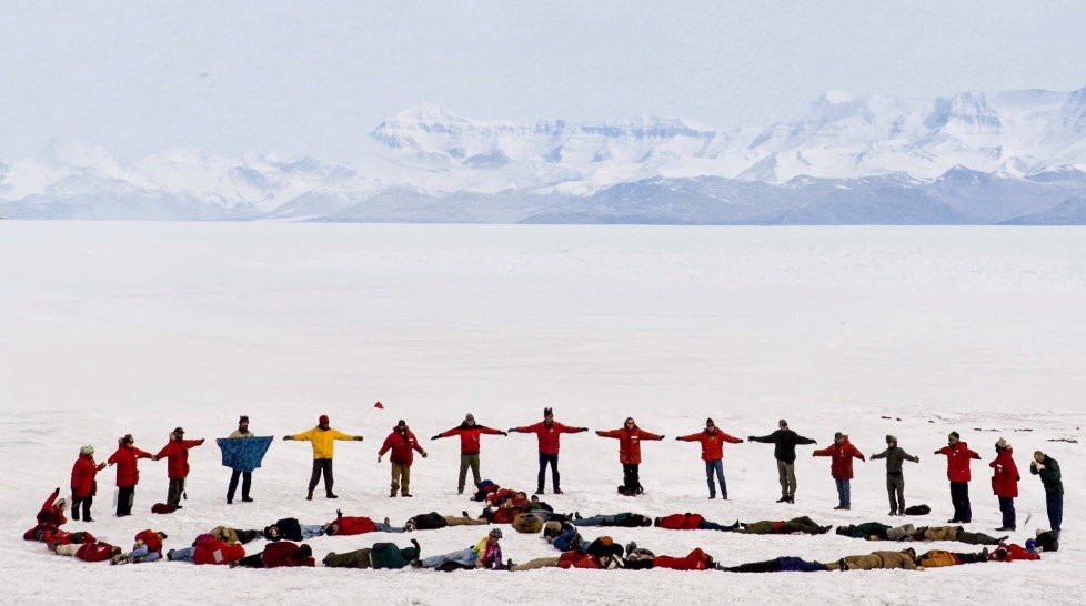 Researchers in Antarctica make a peace sign in the snow to protest the coming war in Iraq.