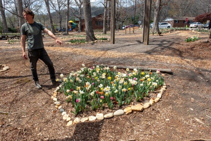 A heart shaped flower bed made from stones that were flung out of the Swannanoa River during last year's floods.