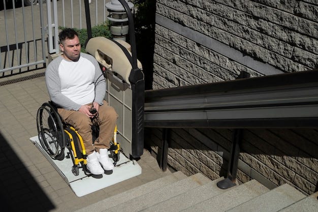 High angle man in wheelchair outdoors at bottom of steps.  he is on a platform lift about to go up.