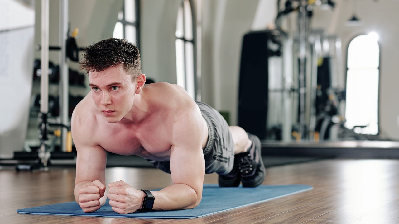 a man planking at the gym