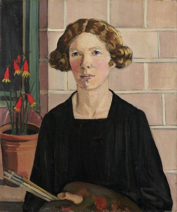 Self portrait of Margaret Preston, a white woman in early middle age with red curly hair parted in the center. She has a resolute gaze and reddened cheeks, and is wearing a black drapey garment and holding a painter’s pallet and three brushes. Behind her is a potted plant with bright red blossoms.