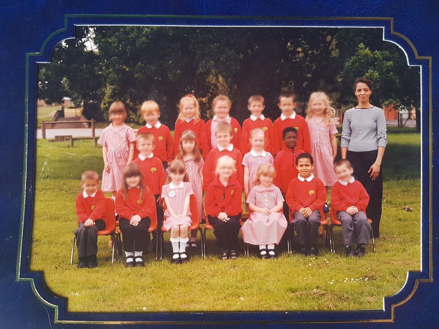 Carli's primary school class photo, with all faces blurred but his and Mrs Milligan's