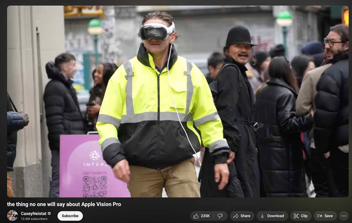 Screenshot from Casey Niestat's Youtube showing him walking on sidewalk and a couple of people are looking at him and laughing because he's wearing the goofy goggles