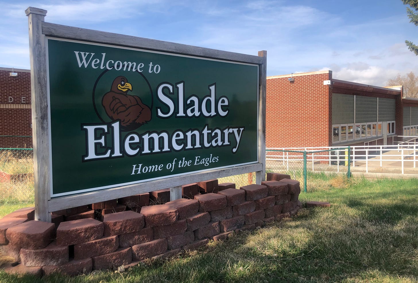 A green sign reads "Welcome to Slade Elementary, Home of the Eagles"