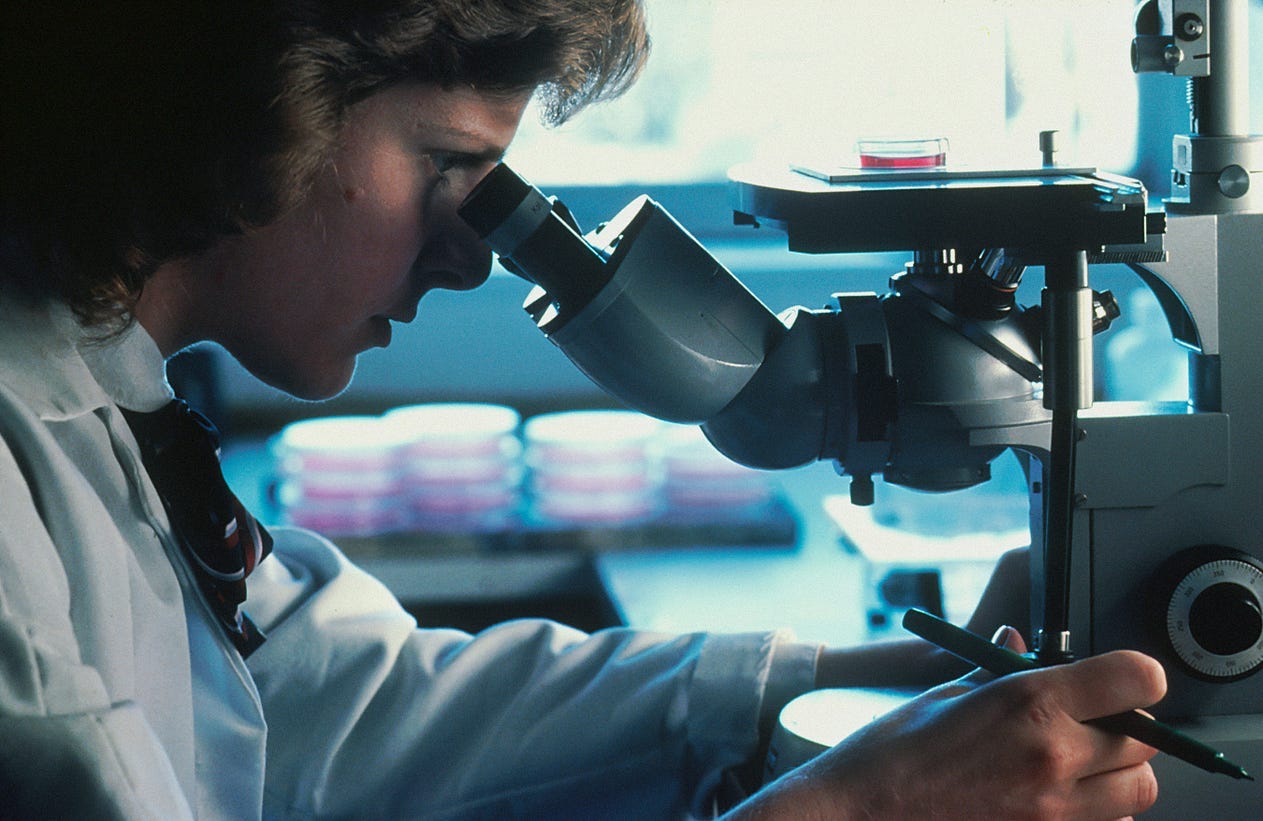 Studious woman in lab researching which cancers are best in this economy