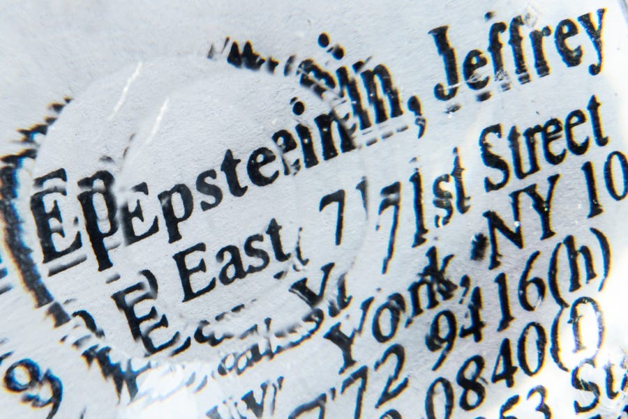 Jeffrey Epstein's name and address printed on paper, distorted through a circular prism.
