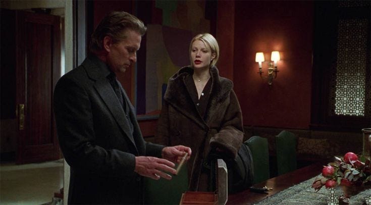 This may contain: a man standing next to a woman at a table