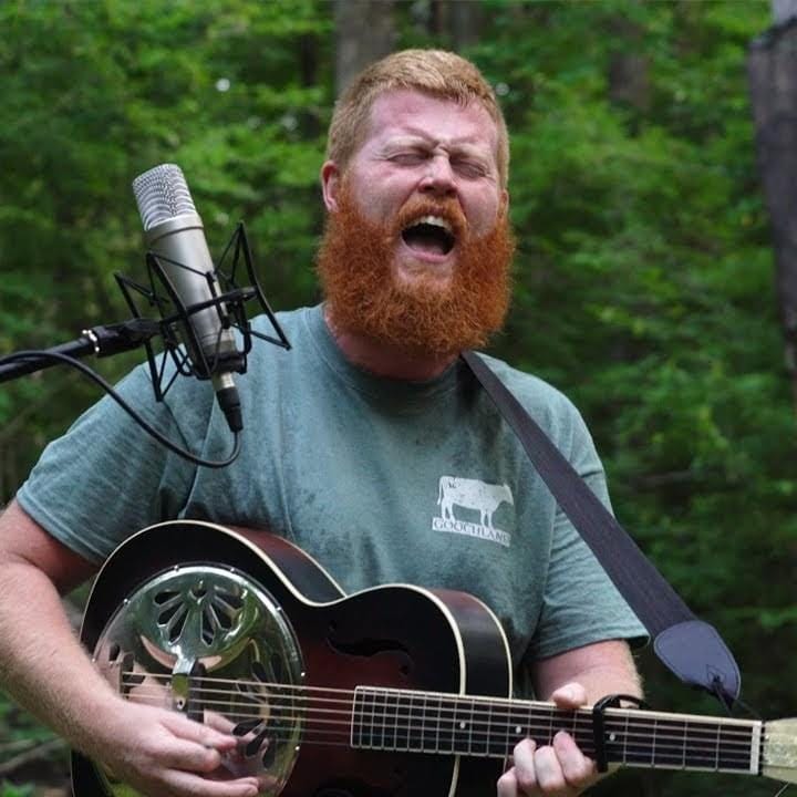 Oliver Anthony performing his bad song “Rich Men North of Richmond” with a bad ginger beard