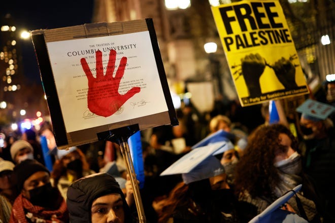 People march as they gather to protest the banning of Students for Justice in Palestine (SJP) and Jewish Voice for Peace (JVP) at Columbia University on November 20, 2023 in New York City.