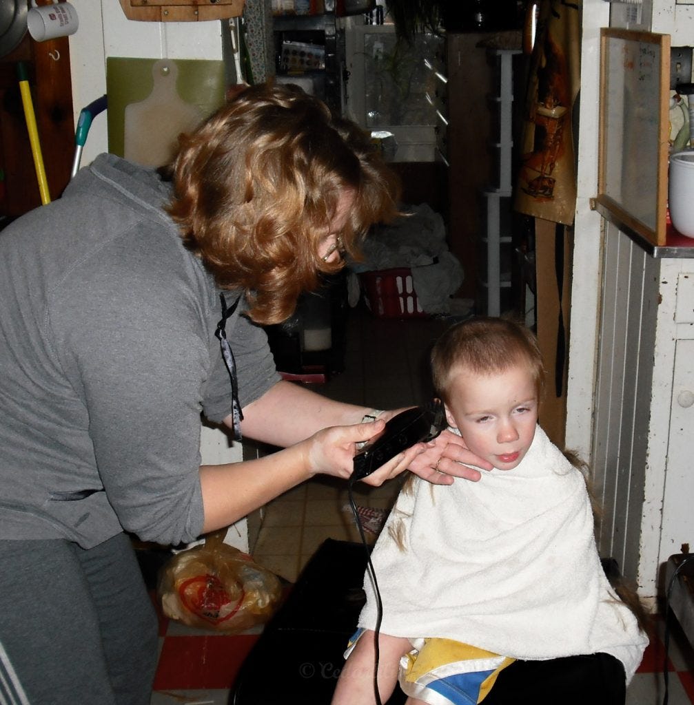 Mama cutting Johann's hair