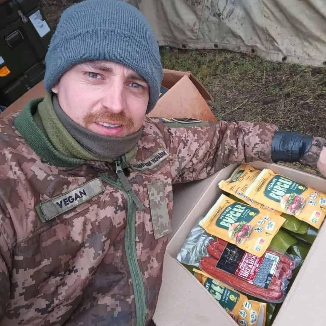 Vegan Ukranian soldier posing next to a box of Vegan food.