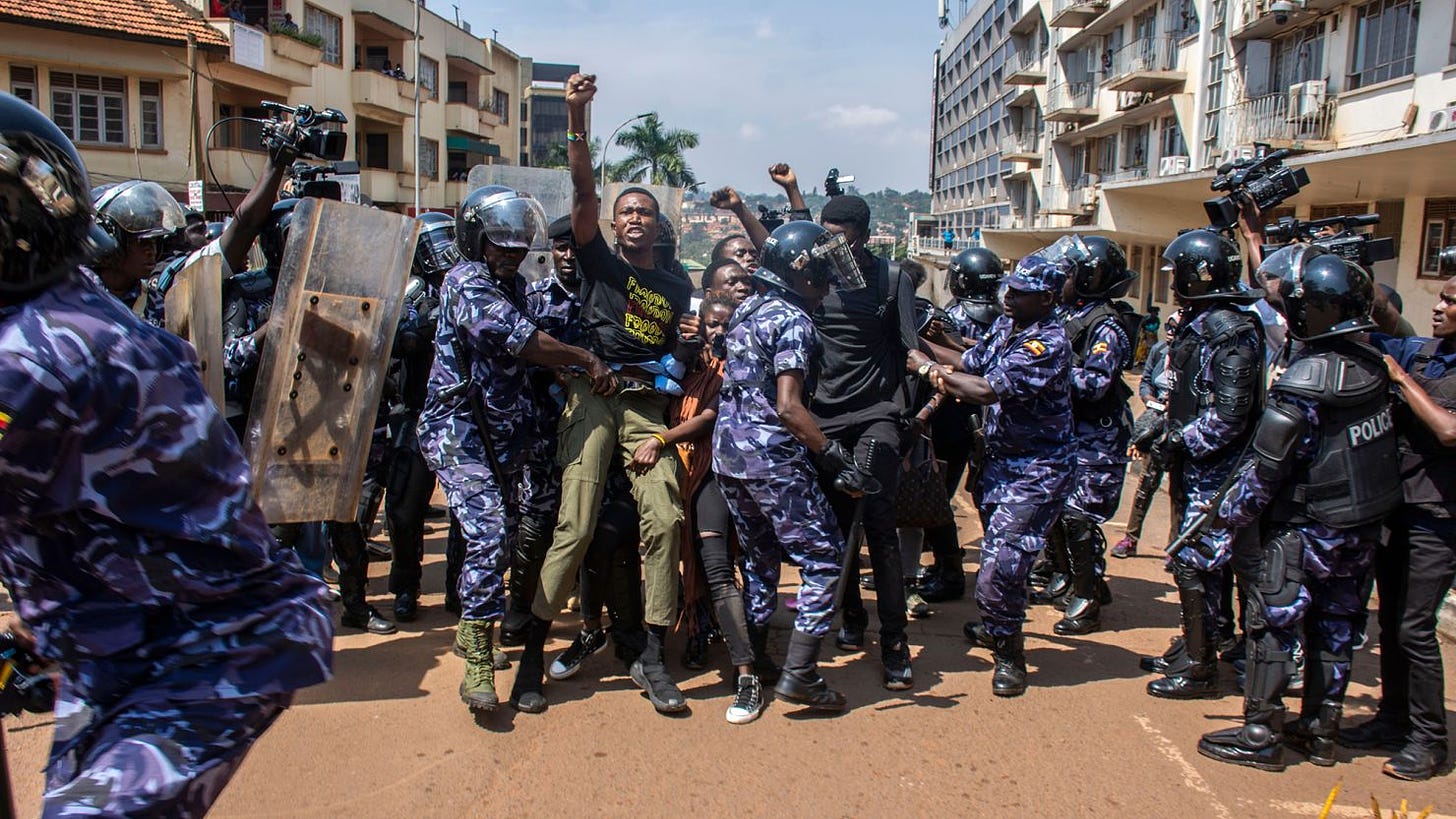 Demonstrators are detained by police after trying to reach the Ugandan Parliament during an anti-corruption march in Kampala on 23 July 2024.