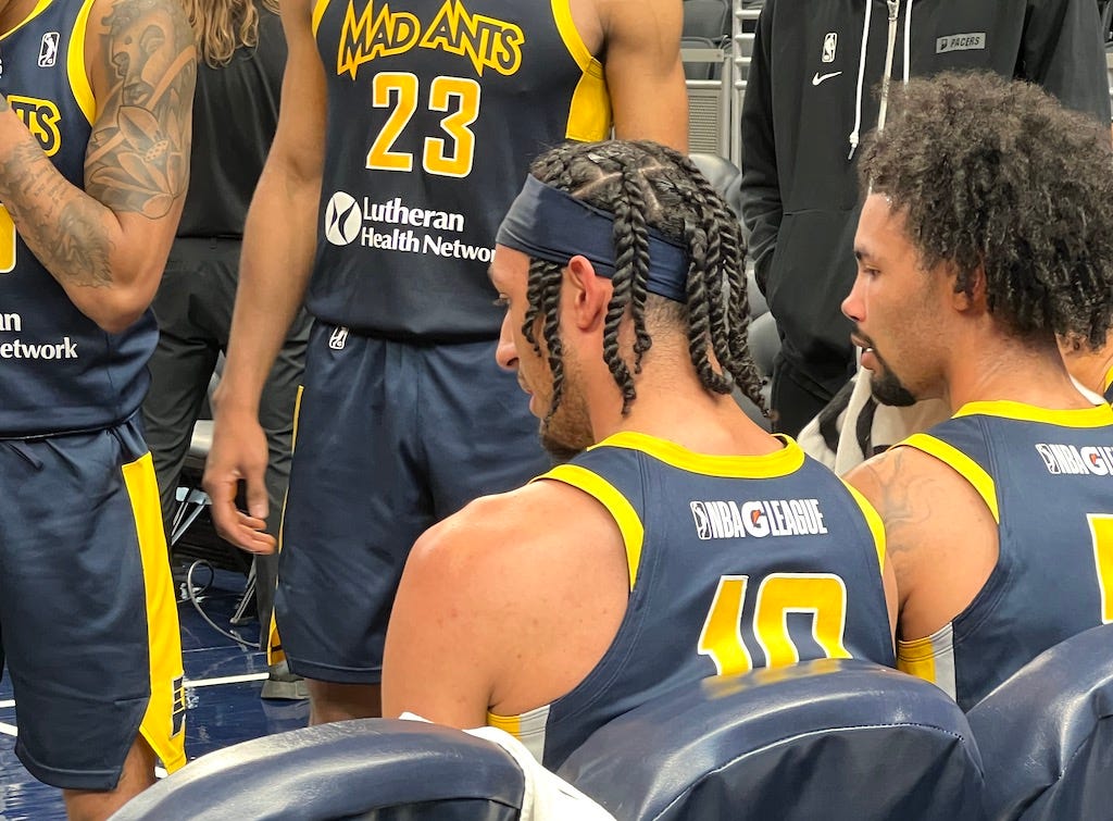 Kendall Brown sitting on the bench during a Mad Ants timeout at Gainbridge Fieldhouse.
