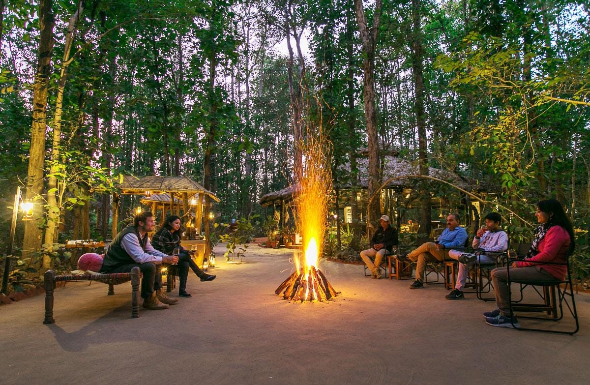 A group of people sitting around a fire

Description automatically generated