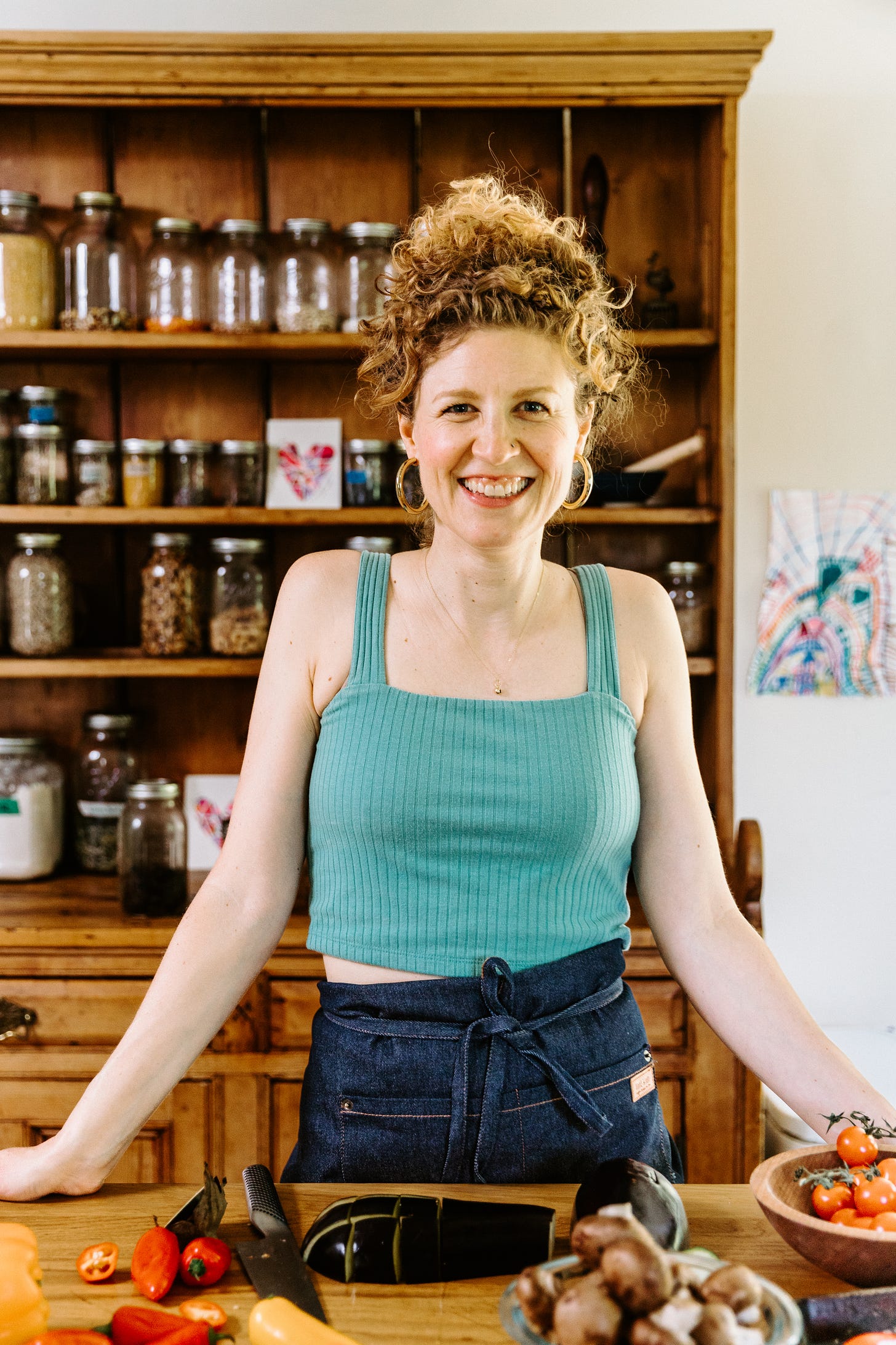 Emma in her kitchen behind a counter with food.