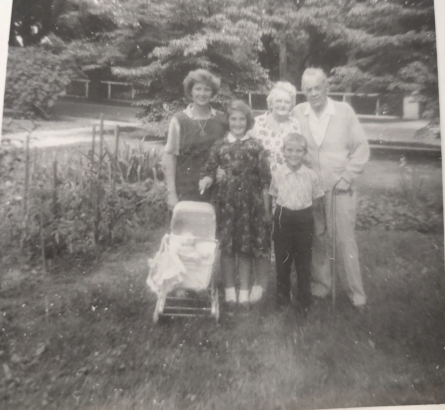 Mom, me, Grandma, Grandpa & younger brother pose in front of Grandpa's sunflower garden