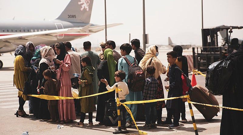 Civilians preparing to be airlifted from Kabul Airport in Afghanistan. Photo Credit: U.S. Marine Corps photo by Staff Sgt. Victor Mancilla/U.S. Central Command Public Affairs, Wikipedia Commons