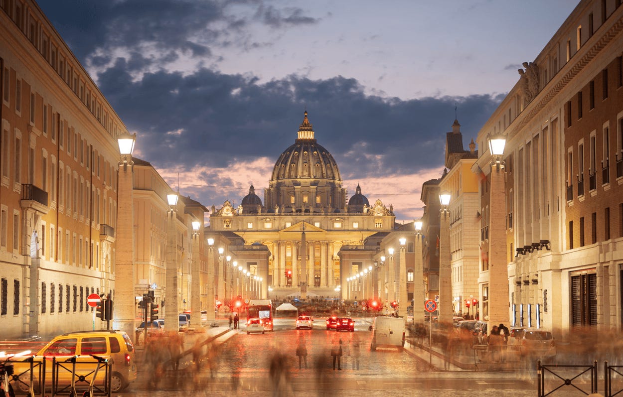 A street with cars and a dome in the background

Description automatically generated