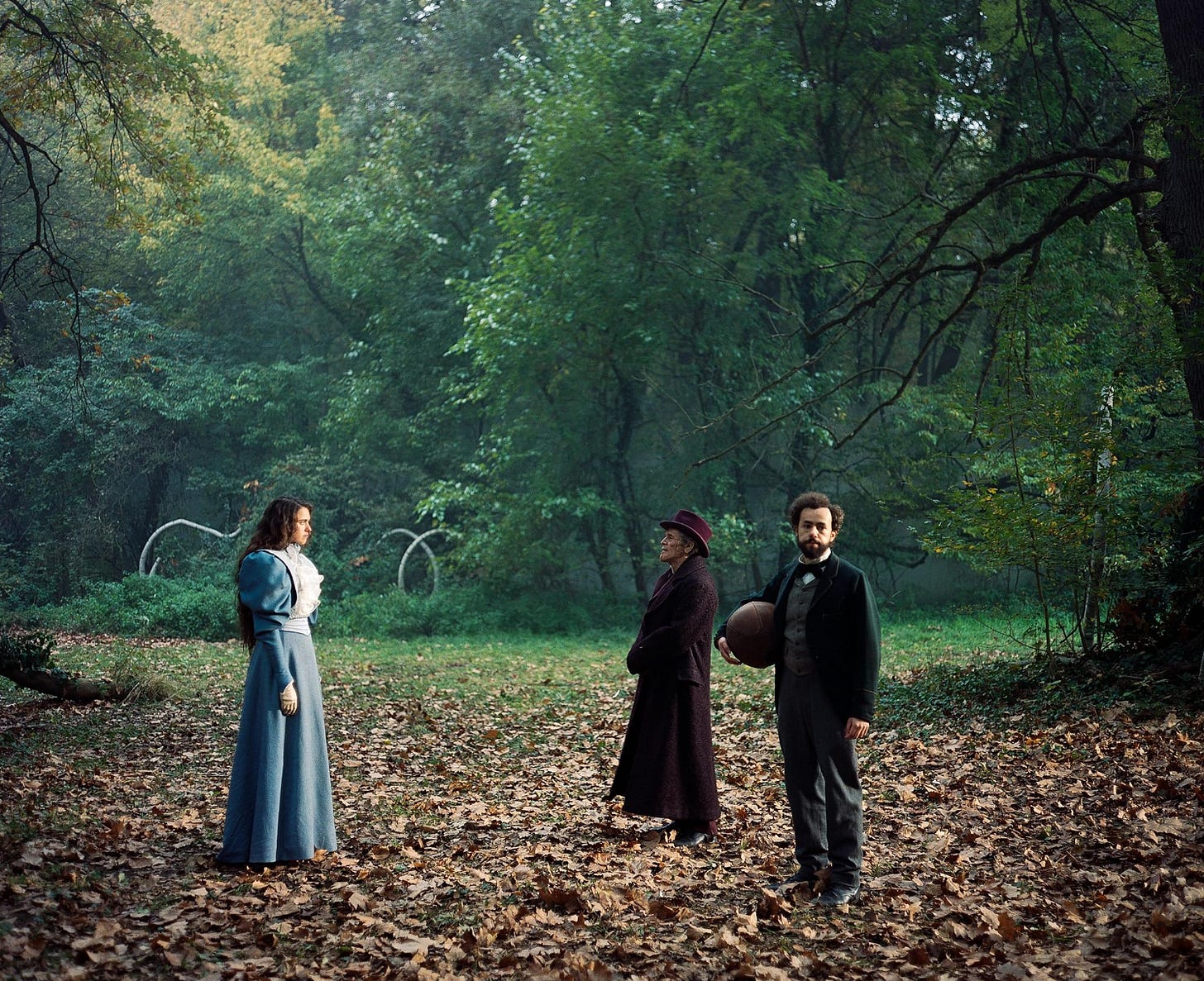 Margaret Qualley, Willem Dafoe, and Ramy Youssef in "Poor Things" (2003)