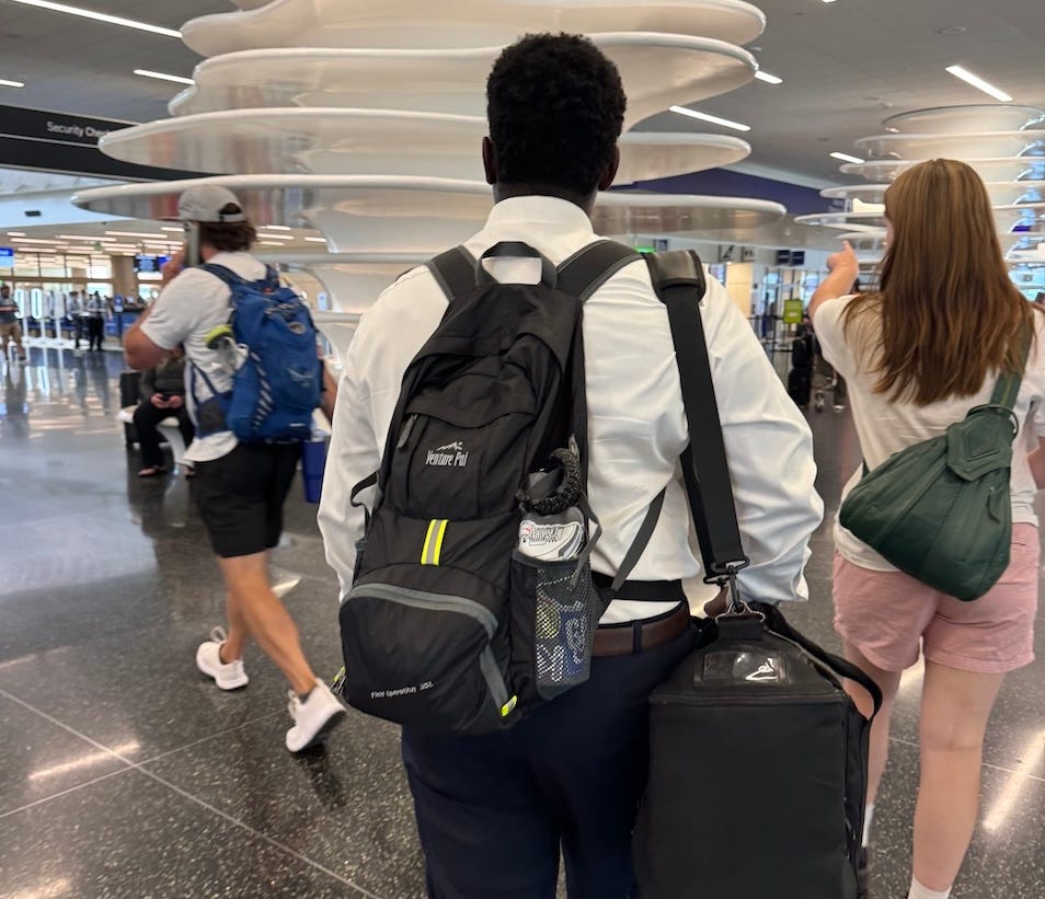 Young man carrying luggage in an airport