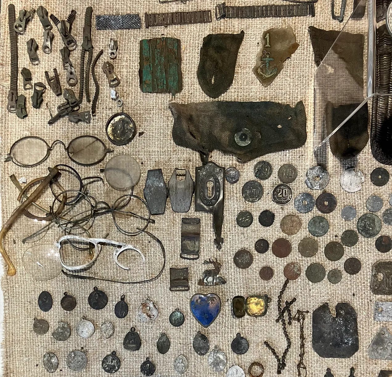 Personal items belonging to POWs like spectacles and zips