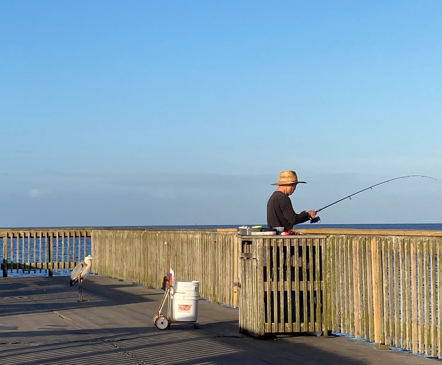 man on a pier fishing