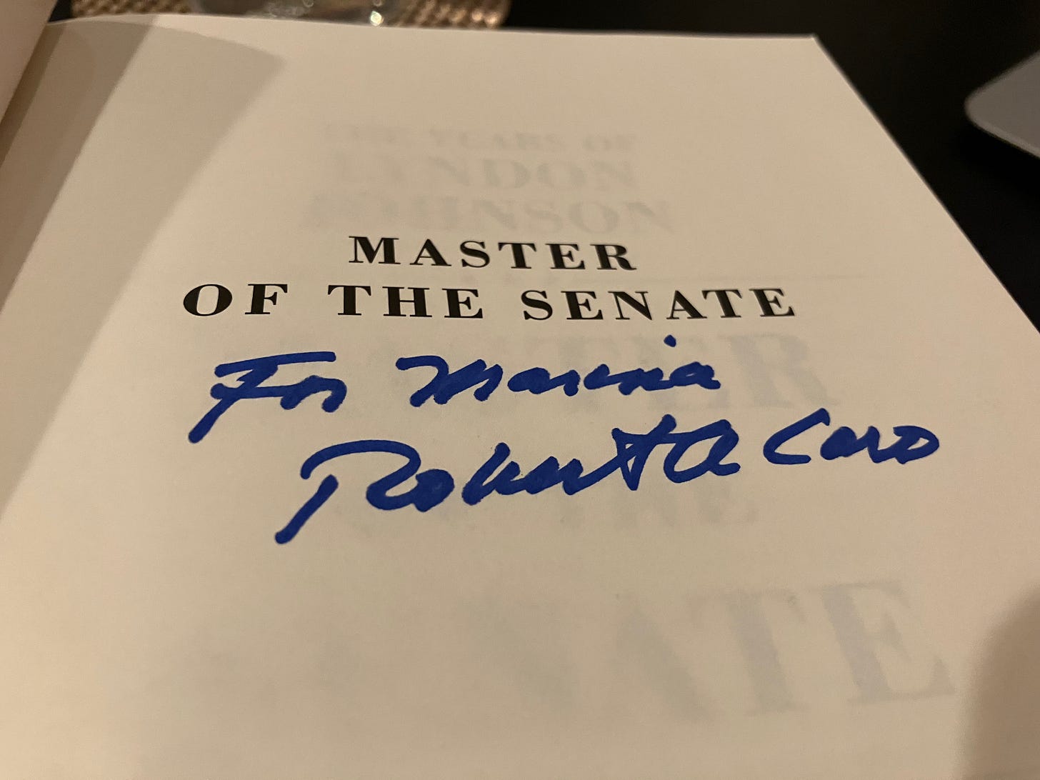 A signed copy of Master of the Senate. The page reads: "For Marina // Robert A. Caro"