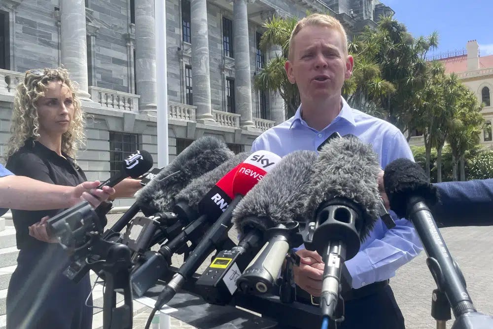New Zealand Education Minister Chris Hipkins talks to reporters outside parliament in Wellington, New Zealand, Saturday, Jan. 21, 2022. Hipkins is set to become New Zealand's next prime minister after he was the only candidate to enter the contest Saturday to replace Jacinda Ardern. (AP Photo/Nick Perry)