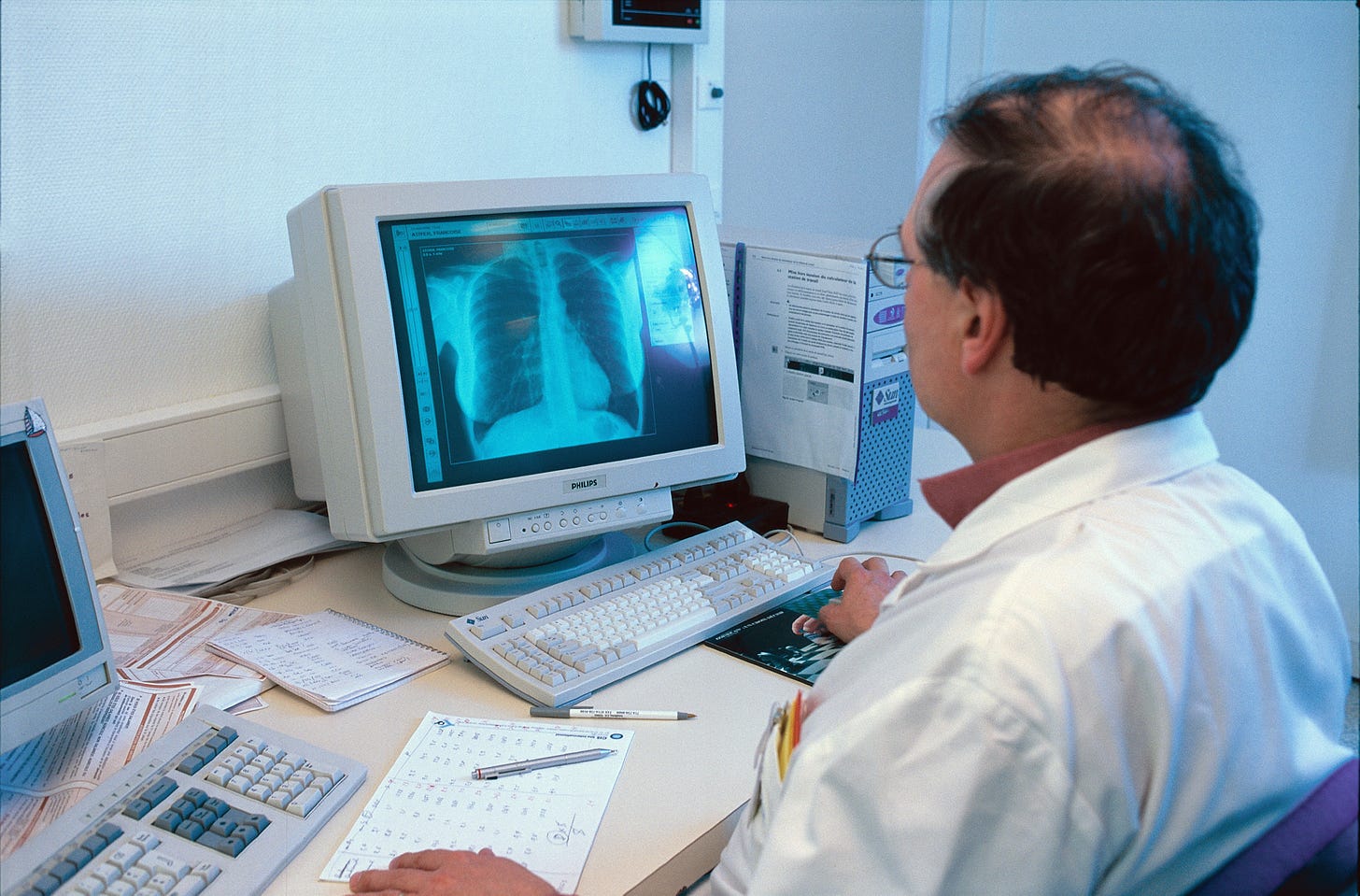 Doctor works on computer (Photo By BSIP/UIG Via Getty Images)