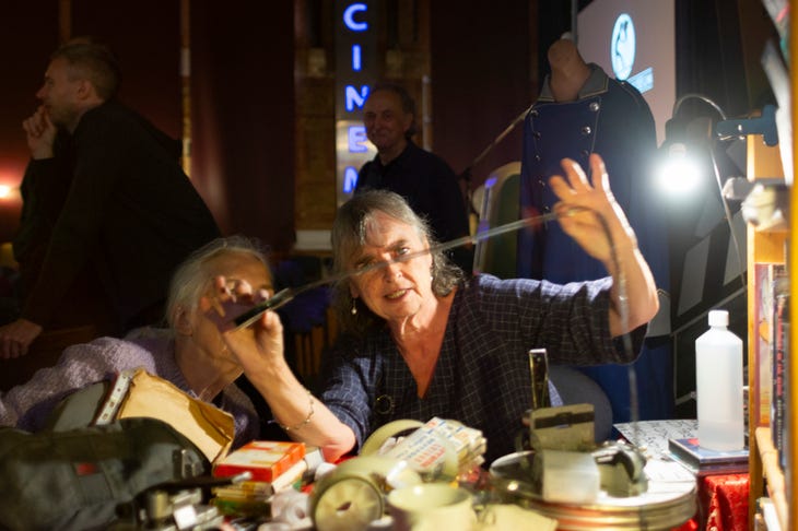 People examining a reel of film