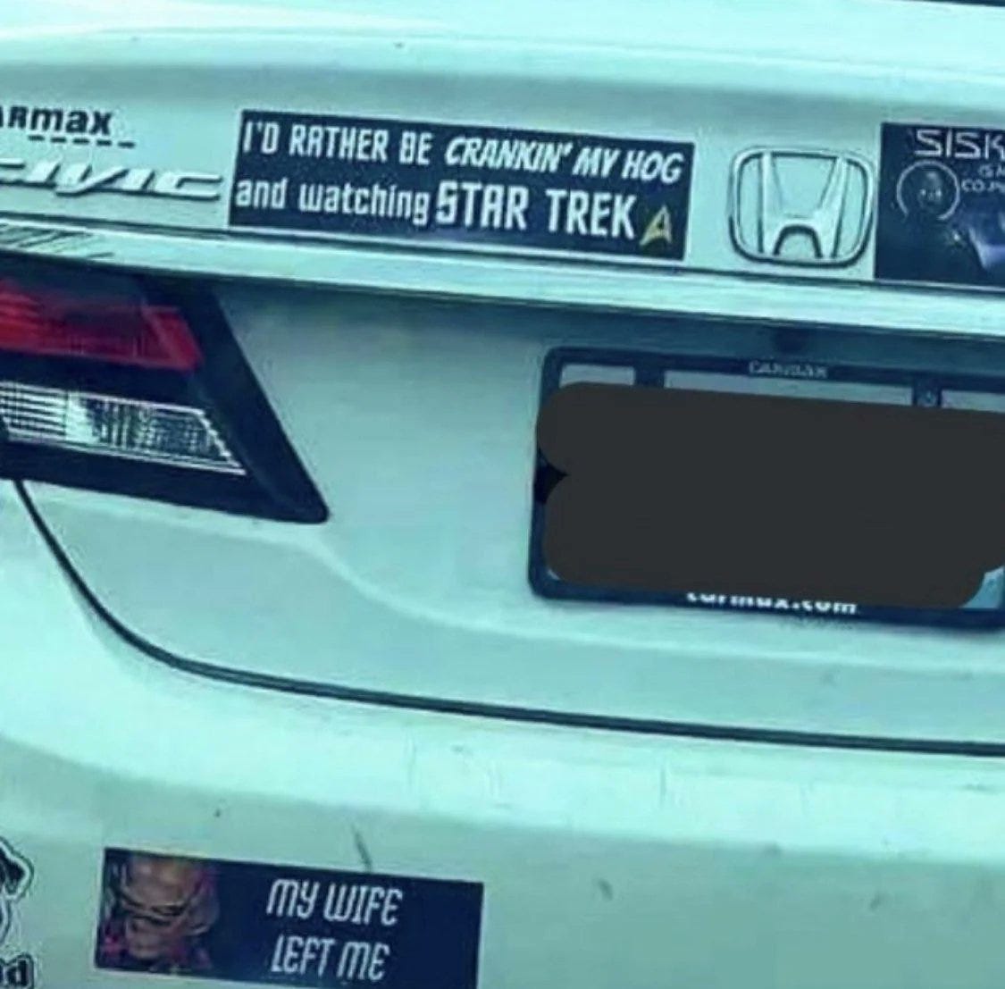Honda Civic with bumper stickers that say I'D RATHER BE CRANKIN' MY HOG AND WATCHING STAR TREK and SISKO IS MY CO-PILOT and one with Quark wearing sunglasses that says MY WIFE LEFT ME