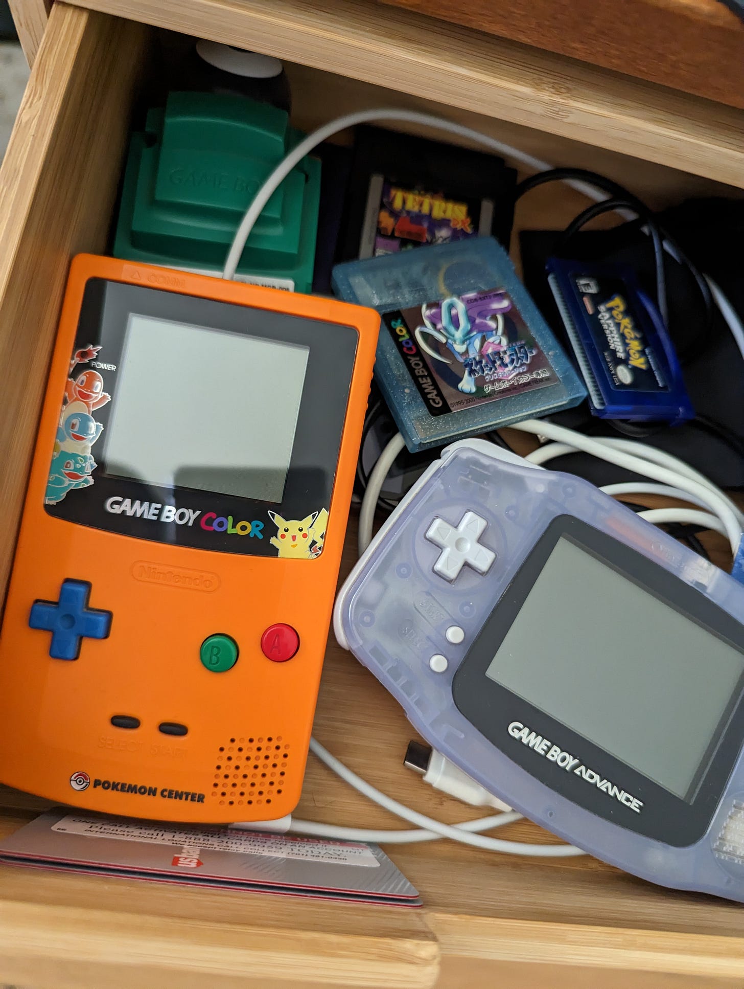 Ryan still has a lot of his original items from his childhood. In this photo, we can see his copy of Pokémon Sapphire, his Japanese copy of Pokémon Crystal, and his limited edition Pokémon Center 3rd anniversary Game Boy Color console.