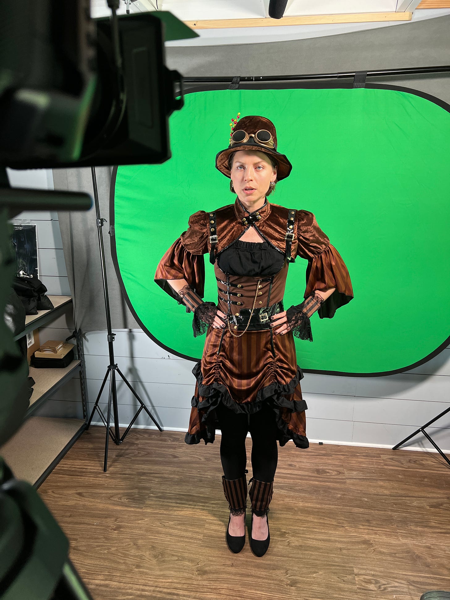 Spurgeon in front of a green screen wearing a steampunk costume