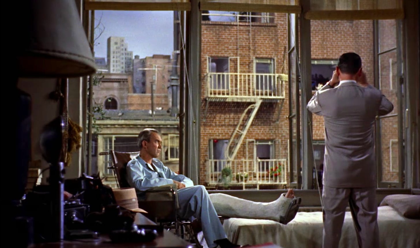 James Stewart as L. B. "Jeff" Jefferies and Wendell Corey as NYPD Det. Lt. Thomas "Tom" J. Doyle in the 1954 Alfred Hitchcock film Rear Window. Doyle is using binoculars to looks into a flat opposite. 