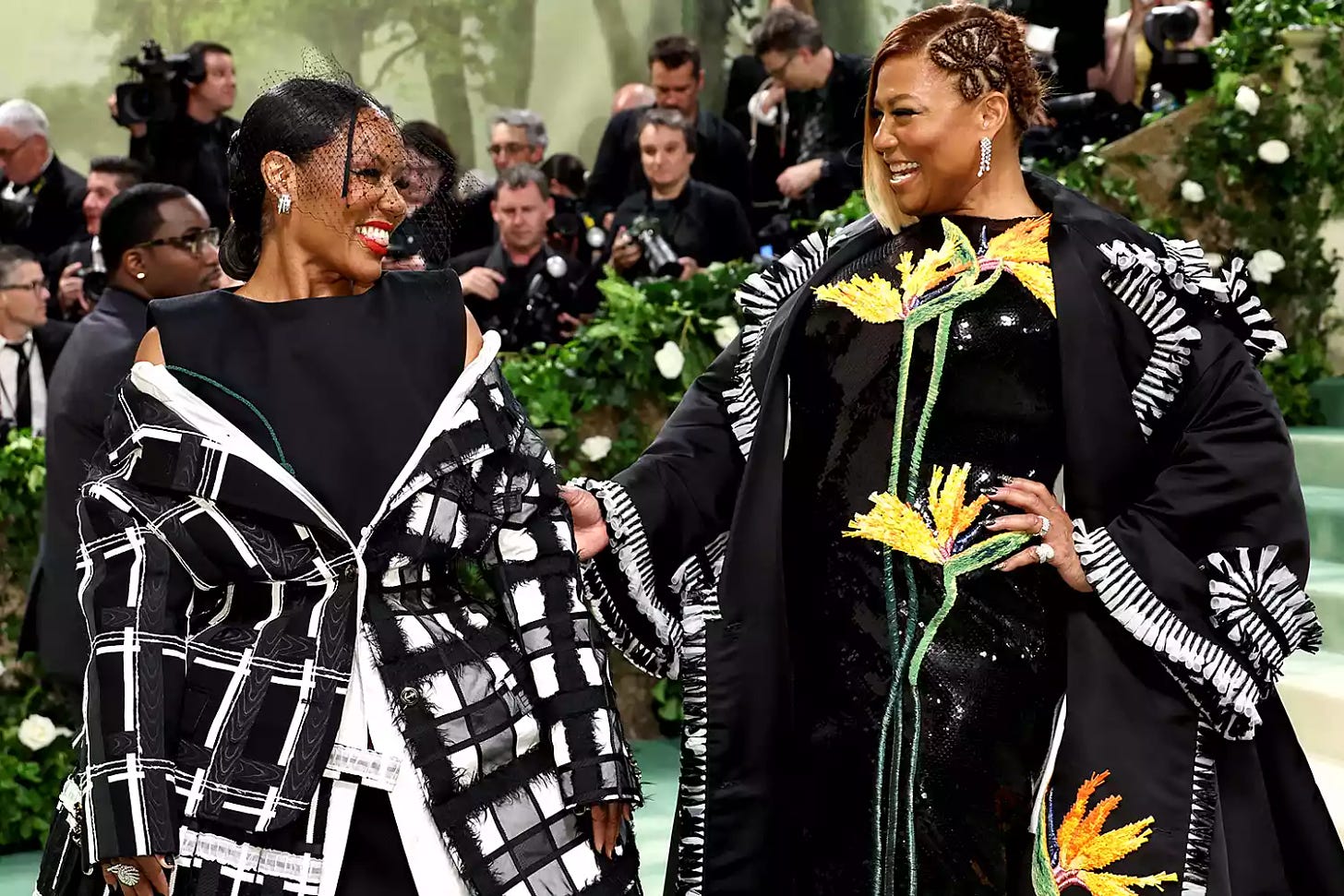 Eboni Nichols and Queen Latifah attend The 2024 Met Gala Celebrating "Sleeping Beauties: Reawakening Fashion" at The Metropolitan Museum of Art on May 06, 2024 in New York City.