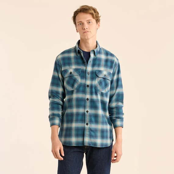 A person in a blue Pendleton Men’s Plaid Burnside Doublebrushed Flannel Shirt.