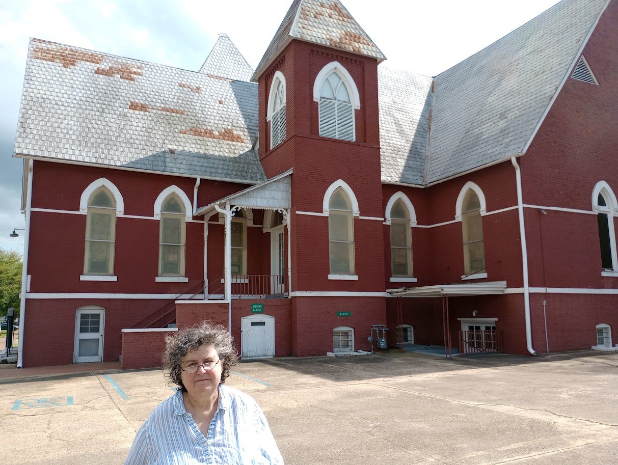 Annette with brick church Annette with brick church