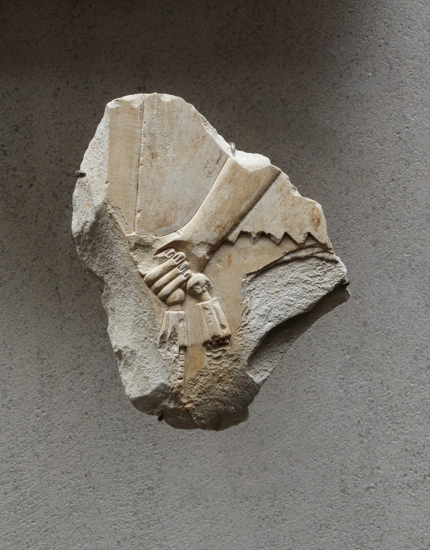 Relief of an attendant's hand holding a necklace - see 26.3.353-3, Limestone, paint