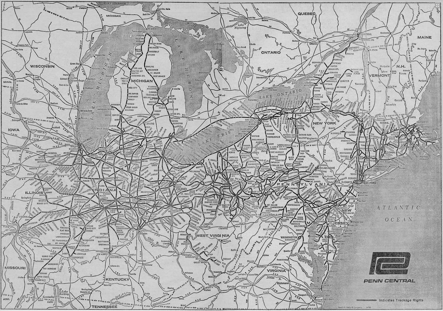 A black-and-white map from 1969 showing the Penn Central Railroad network across the northeastern and midwestern United States, including trackage rights. The map covers areas from the Atlantic Ocean to Illinois, Michigan, and Wisconsin, and as far south as Kentucky and Virginia. Prominent geographic features such as the Great Lakes (Lake Michigan, Lake Huron, Lake Erie, and Lake Ontario) are labeled. Key states on the map include Pennsylvania, New York, Ohio, Indiana, and Illinois, with dense rail lines connecting major cities like New York City, Chicago, Cleveland, Detroit, and Philadelphia. The map features intricate rail line details with station names along routes. A "Penn Central" logo is displayed in the bottom-right corner.