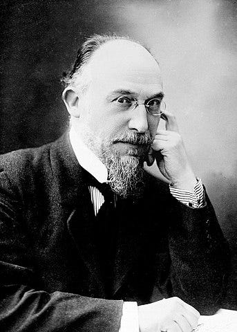 A black and white photo of a bearded fella wearing pince-nez glasses