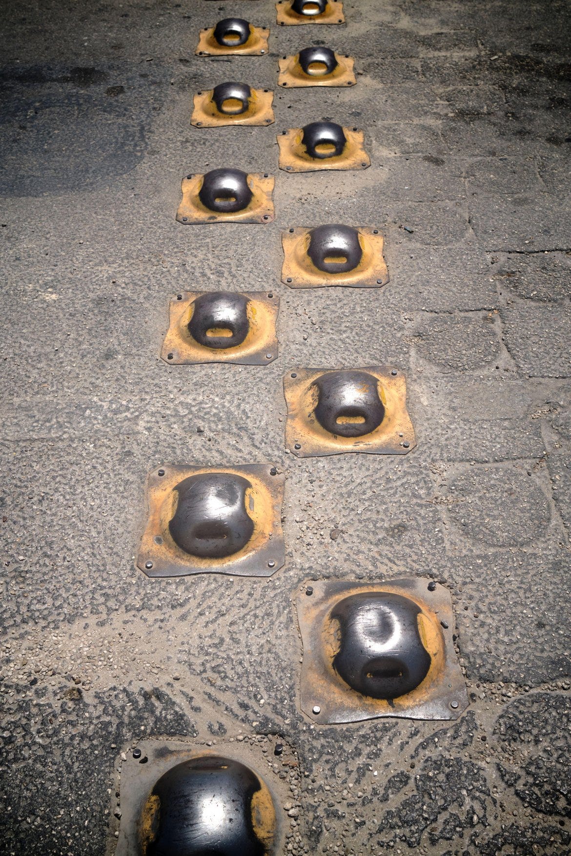 2 rows of steel topes or speed bumps on a road in Mexico