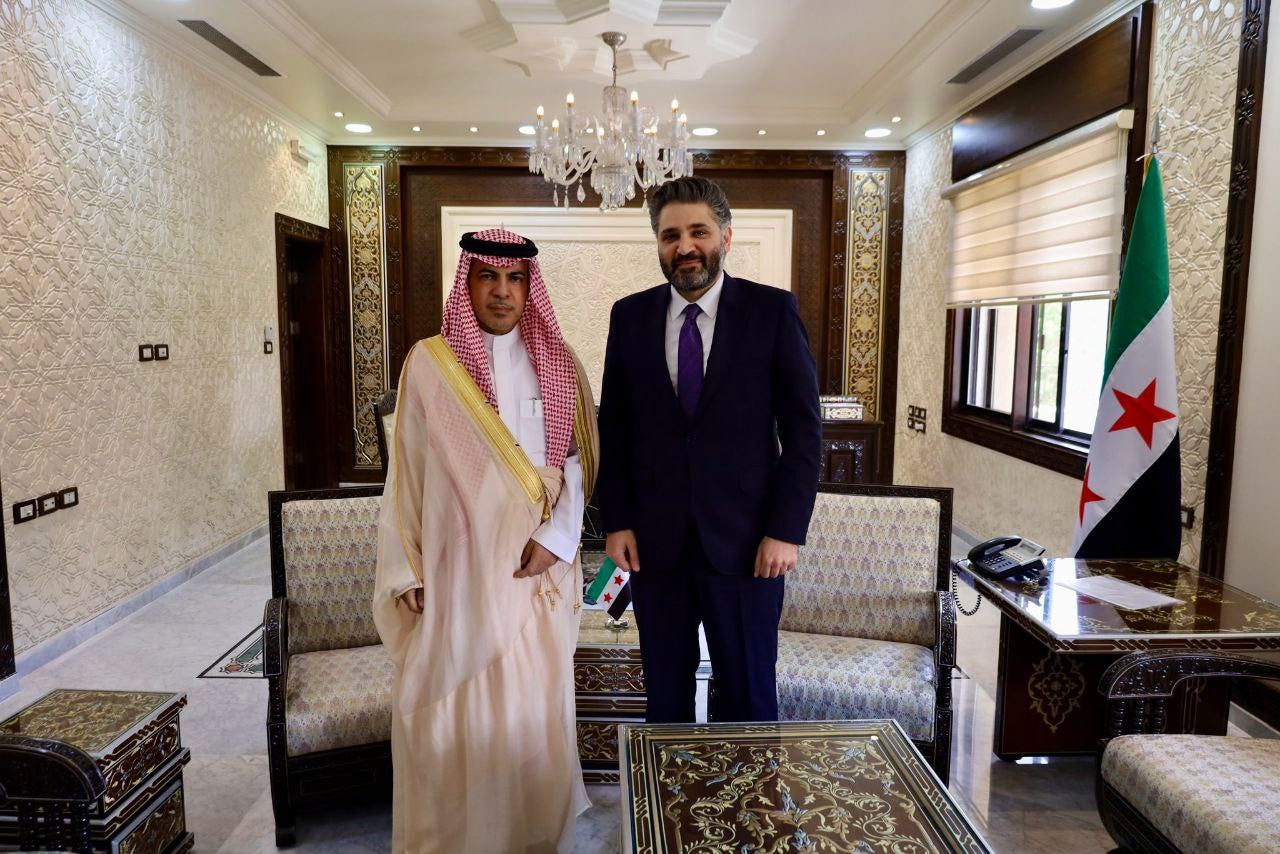 A person in a suit standing next to a person in a suit

AI-generated content may be incorrect.